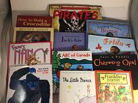 13 brand new hardcover children's books arranged on a flat surface showing covers with various titles and colorful illustrations.