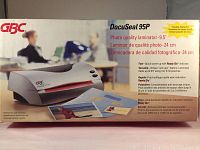 Photo of unopened box for GBC DocuSeal 95P laminator showing product image, features, and specifications including the capability to laminate up to 9.5" wide documents.