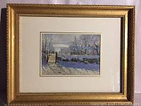 Framed print of The Magpie by Claude Monet with gold frame and cream matting, approximately 14x11 inches.