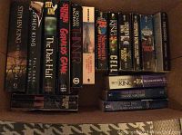 Photo showing spines of various Stephen King novels arranged in a box, clearly displaying titles such as The Dark Half, Full Dark No Stars, Gerald's Game, Thinner, Nightmares & Dreamscapes, Needful Things, Cell, The Dark Tower series, Desperation, and Danse Macabre.
