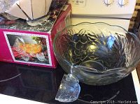 Punch bowl with ladle beside original box with product image and ANCMAR branding visible