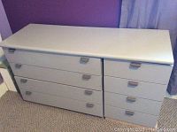 Front view of entire chest of drawers showing three main pieces: the flat top piece and two lower sections with drawers.