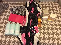 Photo of Avon scarves, wristlet, lotions, and head massager arranged on surface