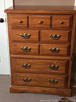 Front view of the medium-sized pine dresser showing brass handles and seven drawers.