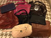 View showing all seven purses arranged on patterned background, highlighting color and styles.
