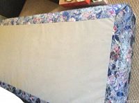 Top view of the twin boxspring showing the floral patterned quilted fabric.