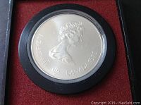 Close-up of the coin obverse side showing Queen Elizabeth II profile with inscriptions 'ELIZABETH II CANADA 1975' in the original mint casing.