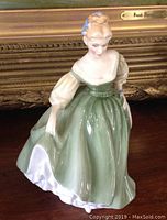 Front-side view of Royal Doulton 'Fair Lady' figurine showing detailed dress and face.