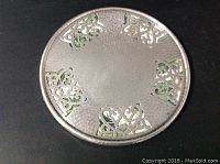 Top view of the silver plated trivet showing hammered texture and pierced art nouveau design.