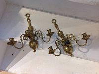 Pair of solid brass wall sconces showing front view and overall shape.