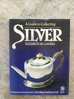Front cover of the book showing the title and author with an image of a silver teapot.