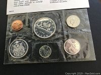 Photo showing all six sealed coins laid out in original packaging: penny, nickel, dime, quarter, half dollar, dollar