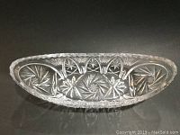 Overhead clear cut crystal centerpiece showing intricate star, fan and pinwheel cut patterns and overall oval shape.