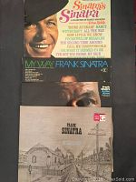 Four Frank Sinatra records stacked slightly overlapping showing album art and titles