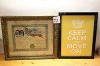 Two framed items on wooden table: an ornate framed 1905 Hamilton Public Schools diploma and a yellow 'Keep Calm and Move On' print in a simple black frame.