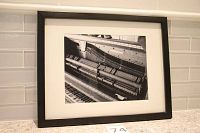 Framed black and white photograph showing the inner strings and mechanics of a piano