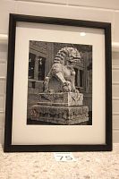 Framed black and white photograph depicting a stone guardian lion statue from the Royal Ontario Museum. Black frame with white mat surrounding the photo.
