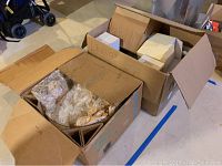 Opened cardboard boxes showing multiple smaller boxes stacked inside, labeled Lenox