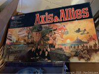 Axis and Allies board game box showing War WWII themed artwork with tanks, planes, ships, and soldiers.