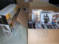 Cardboard box with DDR mat box and assorted game cases
