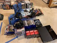 Overview of PS4 console, controllers, headsets, cables, game cases and bottle openers