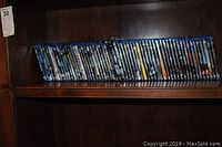 Shelf of approximately 50 Blu-ray DVD cases, showing majority of collection size
