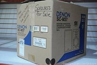 Closed box of Denon SC-M37 speakers showing brand, model, and handwritten notes on box.