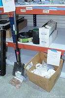 Various PVC pipe fittings in a cardboard box with a note labeled 'VARIOUS PVC PIPE FITTINGS'.