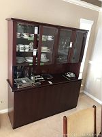 Front view of rosewood cabinet with upper glass doors and lower storage section