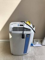 Front view of the Kenmore Elite portable air conditioner showing blue accent and vent grille.