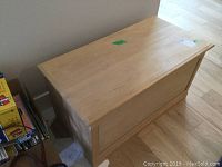 Top and front view of solid wood rectangular storage chest with light finish in good condition.