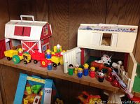 Main display of Fisher Price Play Family Farm barn, tractor with trailers and multiple farm figures.