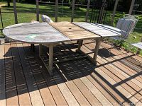 Overview of weathered teak extendable patio table on deck