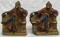 Front view of both antique thespian bookends seated on chairs, showing detailed cold paint in brown, blue, and gold tones.