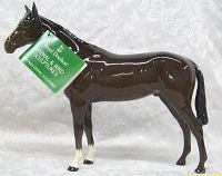 Side profile of horse figurine with Royal Doulton Animal & Bird Sculptures tag visible.
