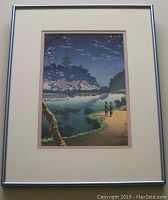 Full-frontal view of framed print showing image, mat and silver metal frame