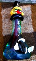 Front and top close-up of the colorful Italian Murano clown statue showing details of the face, hat and collar.