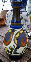 Front-side view of the Gouda pottery vase showing colorful Art Nouveau motifs and baluster form.