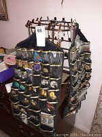 Photo of two black hanging jewelry organizers with clear plastic pockets filled with costume earrings, attached to a dresser.