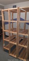 Three wooden shelving units side by side showing height and depth, slatted shelves and wood framing