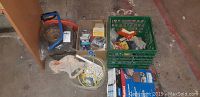 Overview of lot showing saw, wheels, hardware boxes, rope, and crate with small items