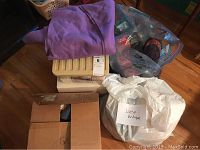 Boxes and bags holding lace, fabric, and yarn