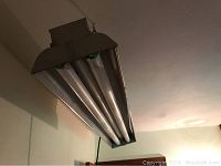 Floor lamp with three fluorescent tubes in dark metal frame