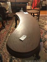 Top view of kidney-shaped wooden coffee table showing smooth surface and curved shape