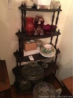 Full view of the wood shelf unit with five levels and various items placed on the shelves (not included in the lot).