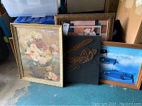 Overall group of seven wall art pieces including floral prints, 3D metal string biplane, and aviation framed print.