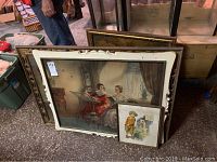 Framed prints leaning against a wall showing front view and grouping of various artwork.