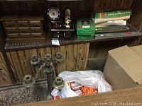 Collection of items including wooden miniature drawers, jewelry box with clock and ballerina, and various boxed candles