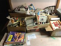 Photo showing several boxes containing assorted model train lights, wiring, and other small accessories along with packages and manuals.