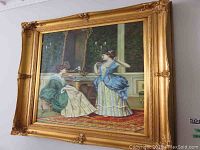 Framed oil painting showing the full view of two Victorian-era women in a period room with ornate frame.